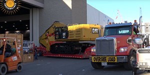 Moving the massive Cat 390F excavator from Conexpo
