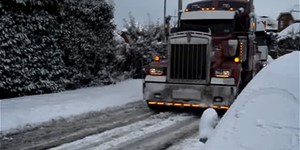 Big Rig Truck Pulls 18 Wheeler Uphill in Snow